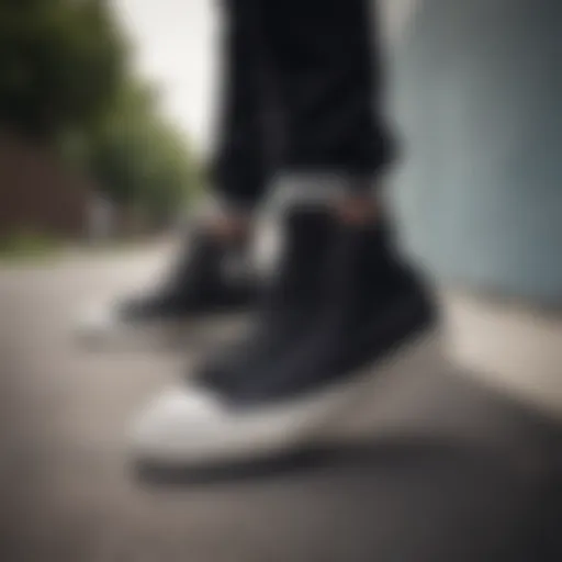 All black Converse high tops on a skateboard