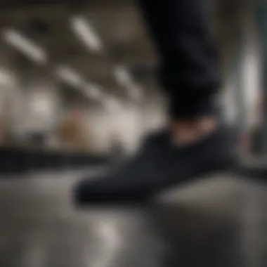 Caring for all black Nike slip-ons, demonstrating maintenance techniques