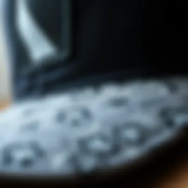 Close-up of the fabric and design details of a black and grey trucker hat