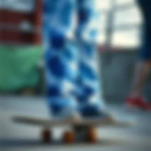 A vibrant pair of blue tie-dye sweat pants displayed on a skateboard