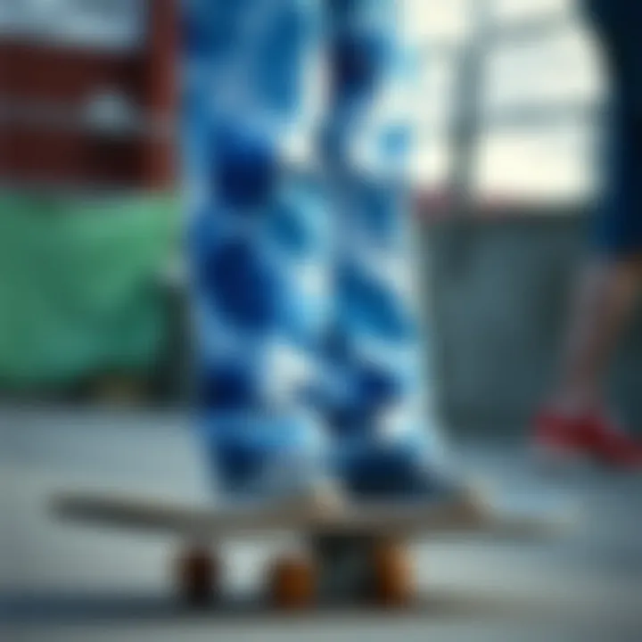 A vibrant pair of blue tie-dye sweat pants displayed on a skateboard