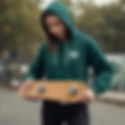 A stylish dark green crop hoodie paired with skateboarding gear.