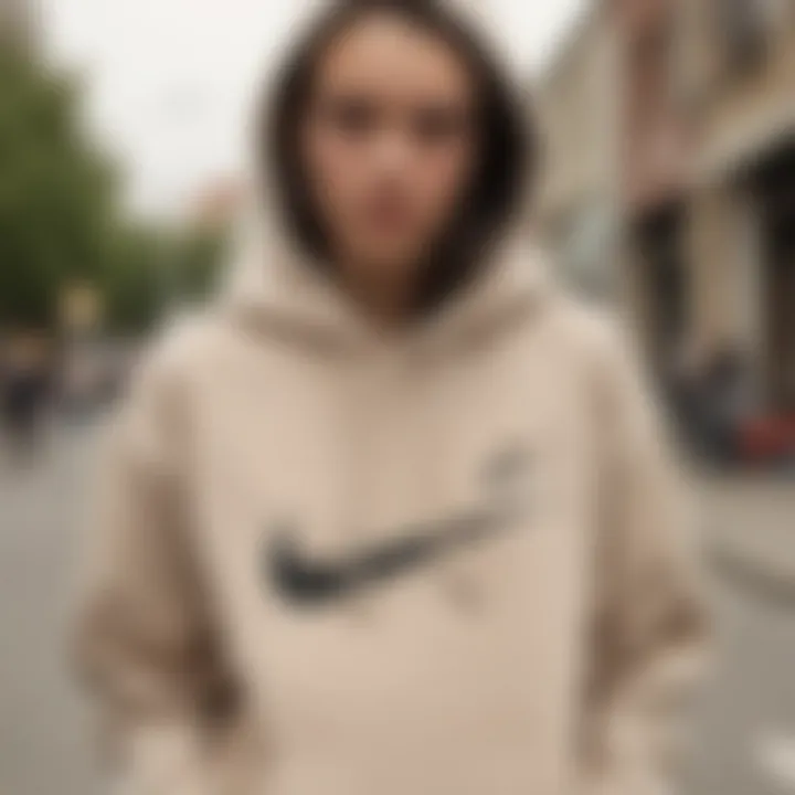 Individual styling a beige Nike hoodie with unique accessories