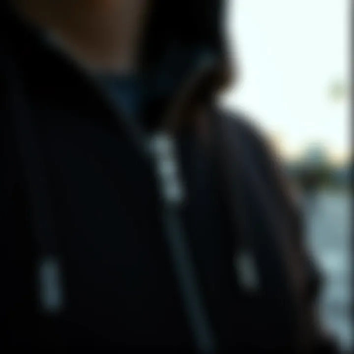 Close-up of the fabric and zipper details of a black full zip up hoodie