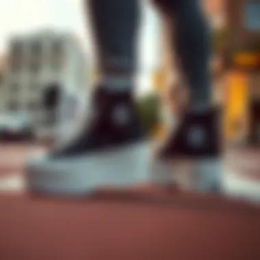 Fashionable urban setting with the black Converse Chuck Taylor platform high tops styled with streetwear
