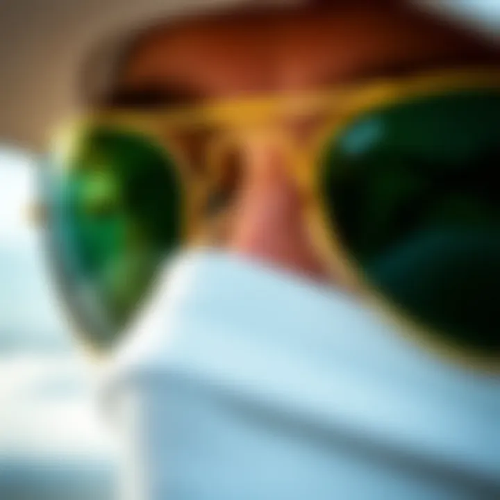 Close-up of gold Ray-Ban Aviators with green lenses