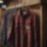 A vintage flannel shirt hanging on a rustic wooden rack