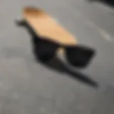 A close-up of black rectangle shades resting on a skateboard deck