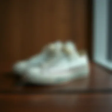 Elegant cream Converse shoes displayed on a wooden surface