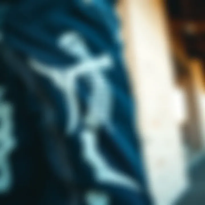 A close-up view of skeleton denim pants showcasing intricate graphic designs