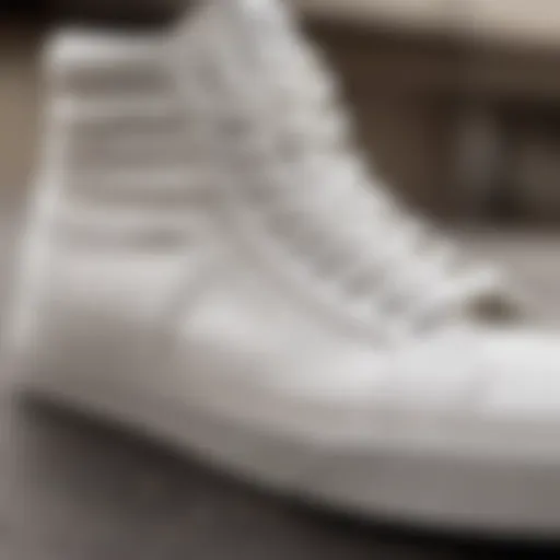 Close-up view of all white leather Vans high tops showcasing the texture and design details.