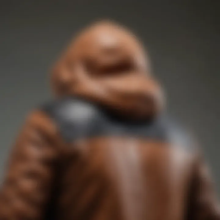 Close-up of the design features of a leather jacket with a hoodie.