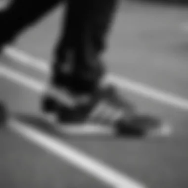 Close-up of black and white Adidas joggers highlighting their design and fabric