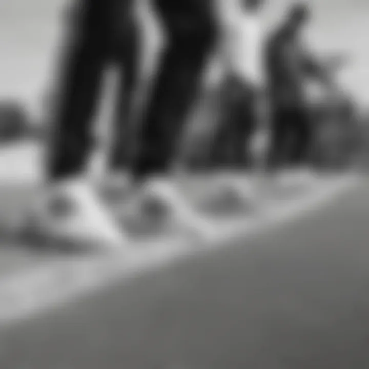 Group of skateboarders wearing black and white Adidas joggers at a skate park