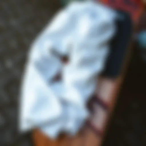 A pair of stylish white baggy pants laid out on a skateboard deck