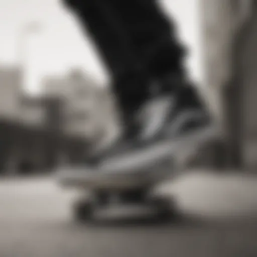 Vans black and white skate shoes on a skateboard